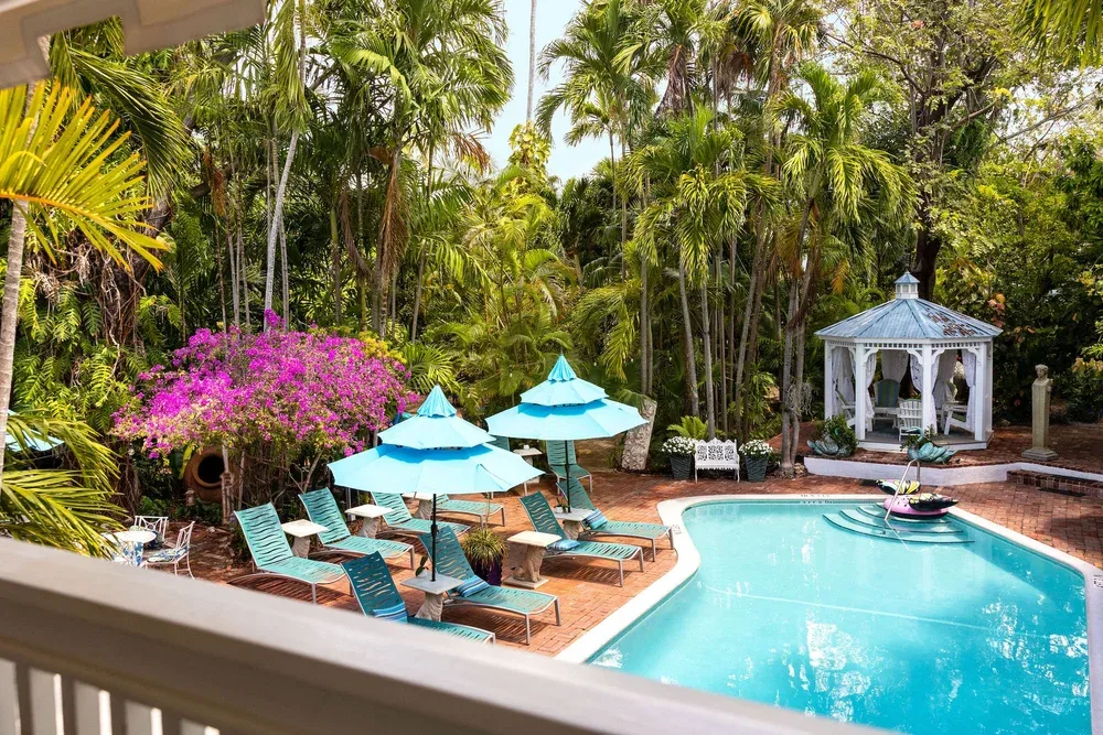 Pool and shaded tropical gardens at The Gardens Hotel